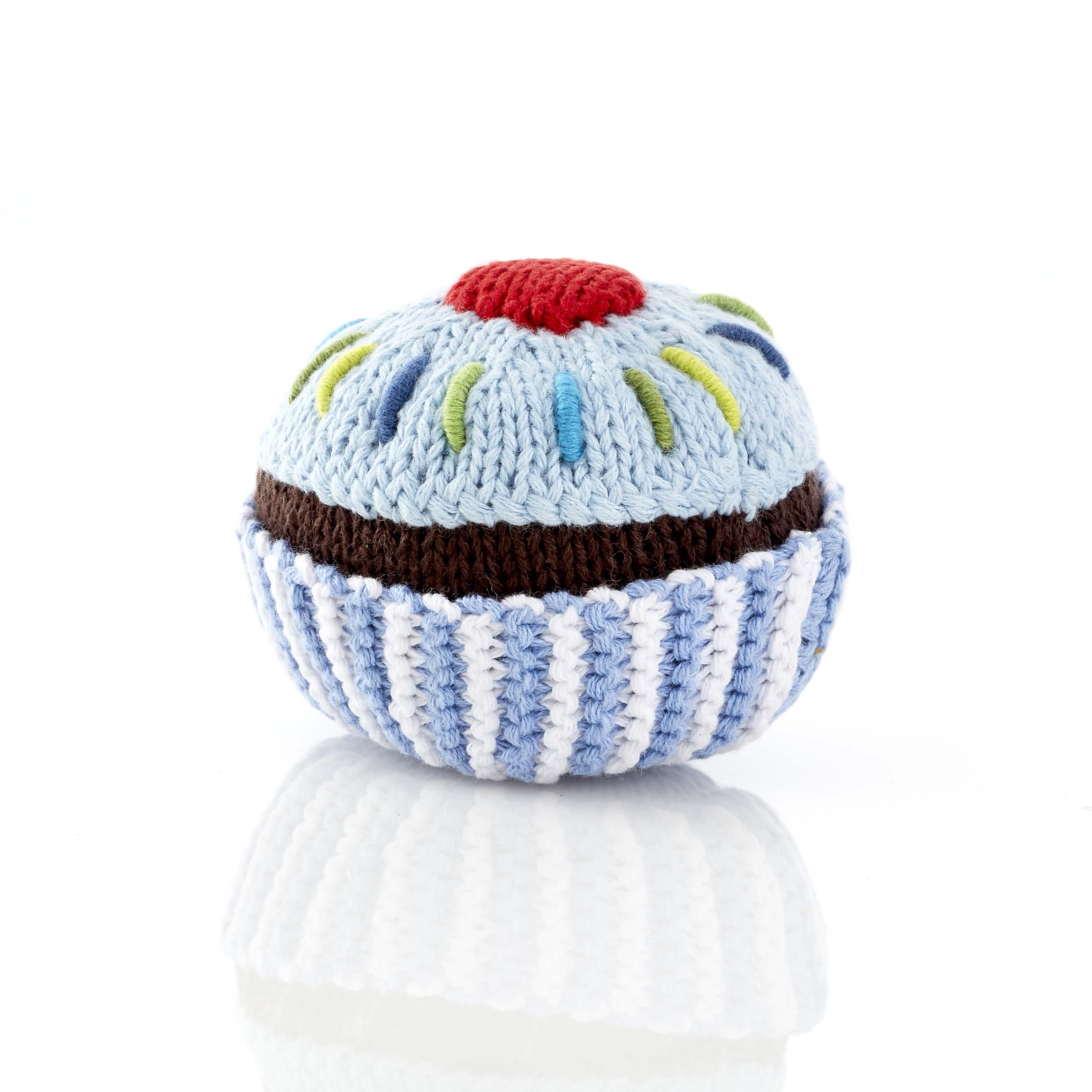 small blue cupcake baby rattle with pale blue icing and cherry on top